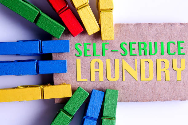 istock SELF-SERVICE LAUNDRY CONCEPTUAL. Colorful clothespins isolated on a white background. 1198418399