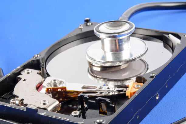 istock RECOVERY AND REPAIR TECHNOLOGY CONCEPT: Hard Disk Drive (HDD) with stethoscope isolated on a blue background 1198419869