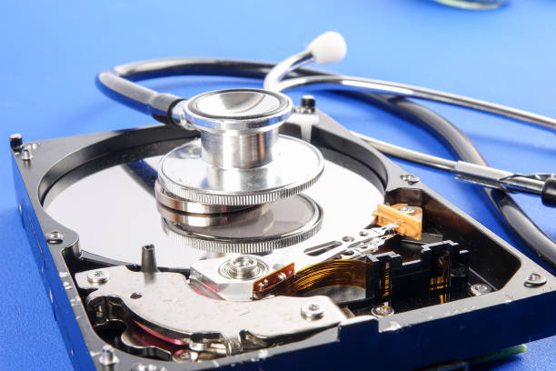 istock RECOVERY AND REPAIR TECHNOLOGY CONCEPT: Hard Disk Drive (HDD) with stethoscope isolated on a blue background 1198419870