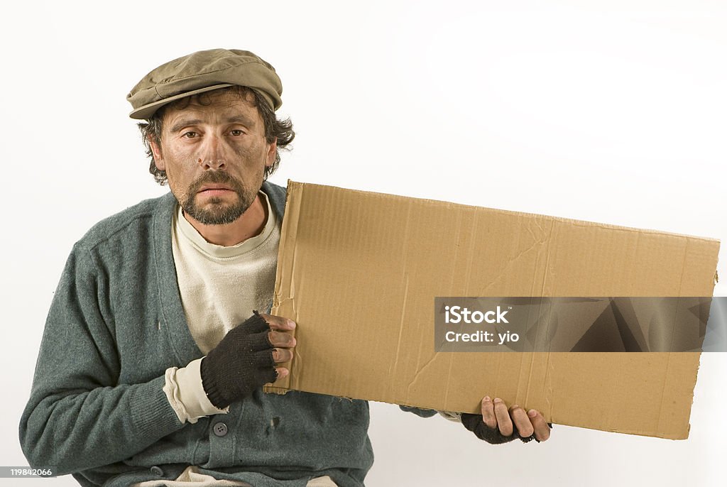 Beggar Holding a Cardboard and Wearing Worn Clothing  Beggar Stock Photo