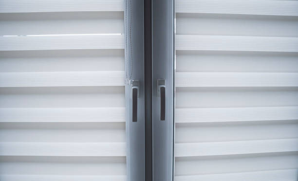 istock White fabric roller blinds on the white plastic window in the living room. Roll curtains indoor. 1198421661