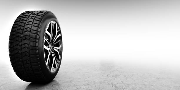Winter tires with alloy wheel lying on snow against white background