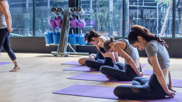 istock Yogs class. Group of sporty people practicing yoga 1198421918
