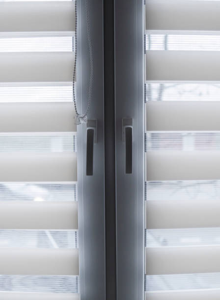 istock White fabric roller blinds on the white plastic window in the living room. Roll curtains indoor. 1198422065