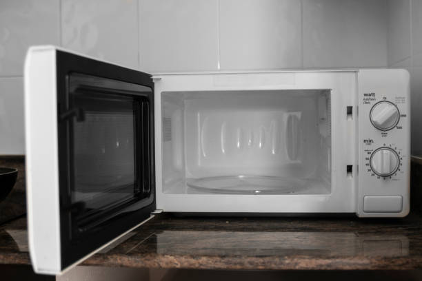 istock Microwave in a kitchen for cooking or heating a dish. 1198422320