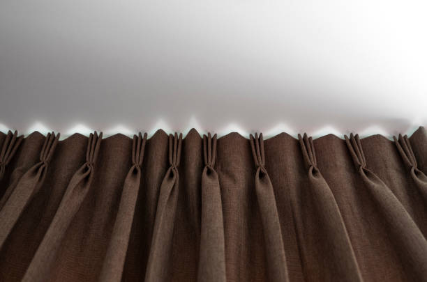 istock Brown curtains on a rail with a white ceiling. Curtain interior decoration in living or sleeping room. Comfortable live in your own home. Sweet confy home. 1198423100