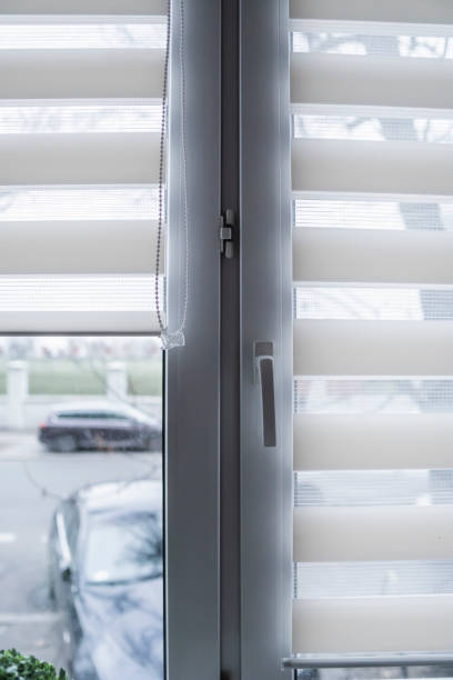 istock White fabric roller blinds on the white plastic window in the living room. Roll curtains indoor. 1198423301