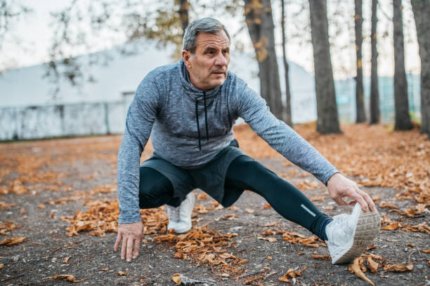 istock Senior man jogging in a public park 1198423320