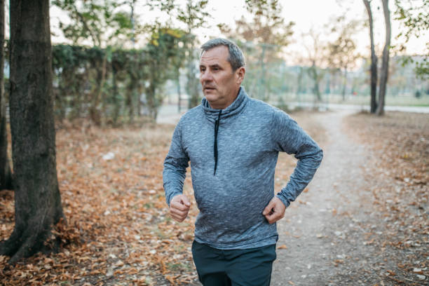 istock Senior man jogging in a public park 1198423349