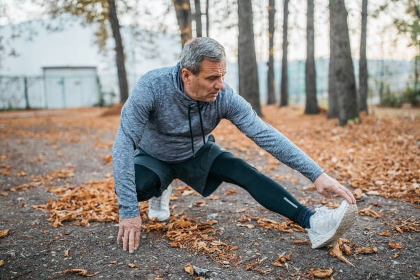 istock Senior man jogging in a public park 1198423358