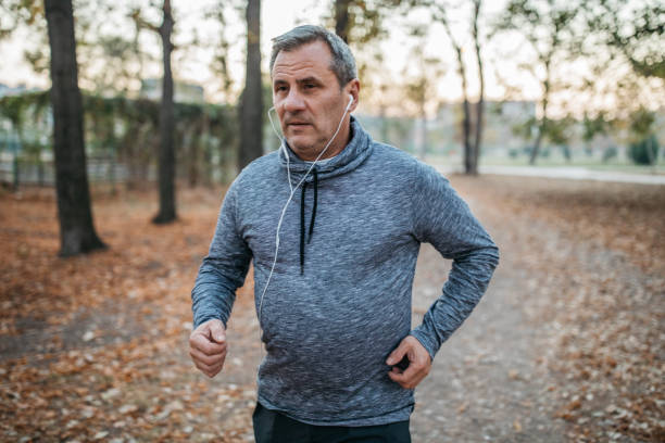 istock Senior man jogging in a public park 1198423411