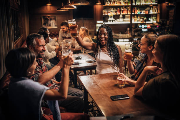 istock Group of friends drinking beer in the pub 1198424219