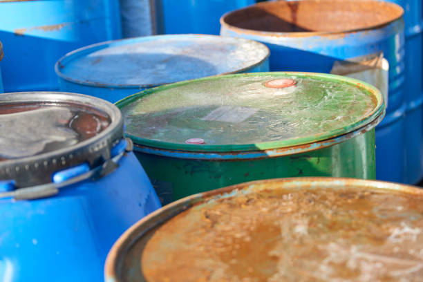 istock Recycling industry - Rusty metal barrels stacked in rows, toxic waste 1198424561