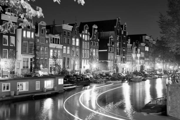 istock Amsterdam canal houses at night 1198424631