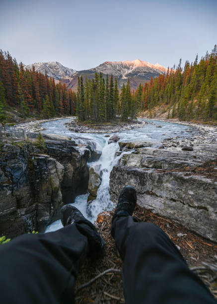 istock Legs traveler sit stretching on Sunwapta Falls in Icefields Parway at Jasper national park 1198426214