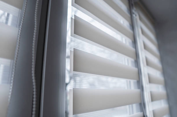 istock White fabric roller blinds on the white plastic window in the living room. Roll curtains indoor. 1198427165