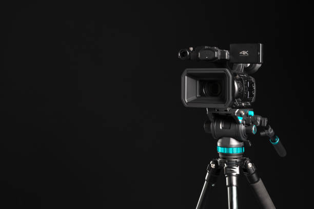 istock Professional 4K video camera on black background , copy space 1198429805