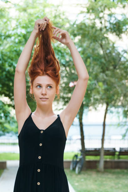 istock Ginger girl posing in park. 1198429917