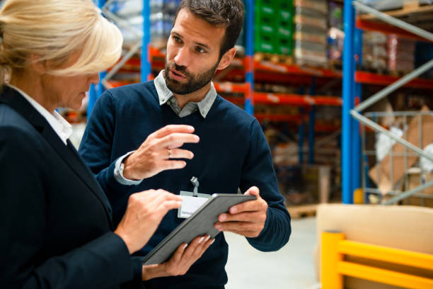 istock Managers in Warehouse discuss about business 1198430060