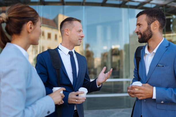 istock Three business colleagues having discussion while standing outdoors 1198430894
