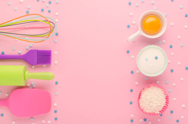 istock baking ingredients, egg, flour, sugar, sweet decoration and kitchen tools on pink background with copy space 1198432003