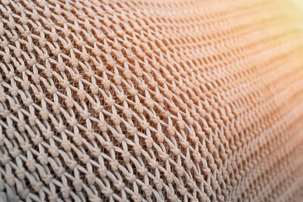 Close up view of fishing net in marine port in the morning. Selective focus. Blurred pattern background.