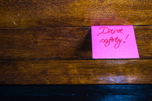 istock Writing Drive safely on memo post reminder. Text Drive safely on sticky paper. 1198434391