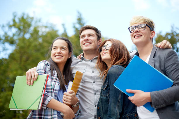 istock group of happy students with folders outdoors 1198434817