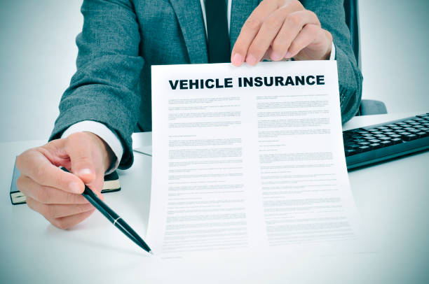 istock young man in suit showing a vehicle insurance policy 1198437366