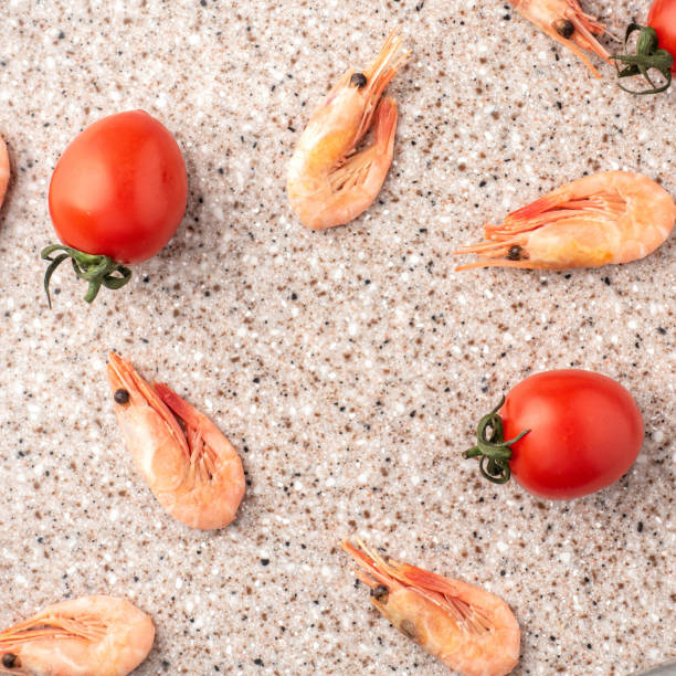 Tomatoes and curves on a kitchen cutting board made of artificial stone.