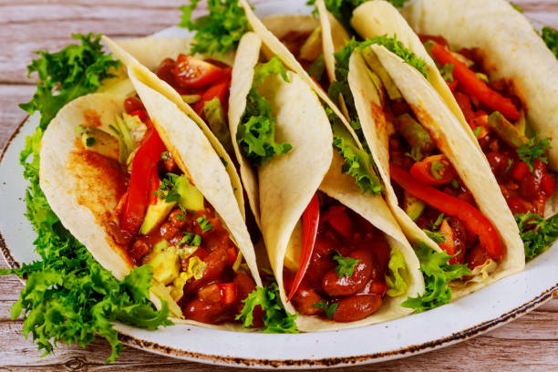 istock Colorful tortillas with beans, beef and vegetable with salsa. 1198441929