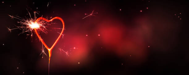 istock burning heart shape sparkler at night 1198443015