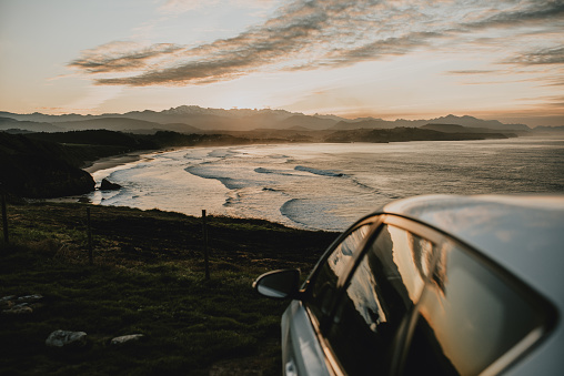 A car by a beach at sunset