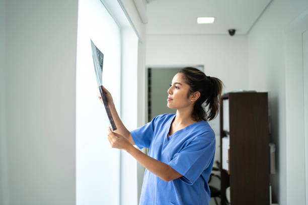 istock Female nurse analyzing medical x-ray 1198447881