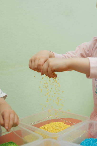 istock Children play educational games with a sensory bin in kindergarten 1198448078