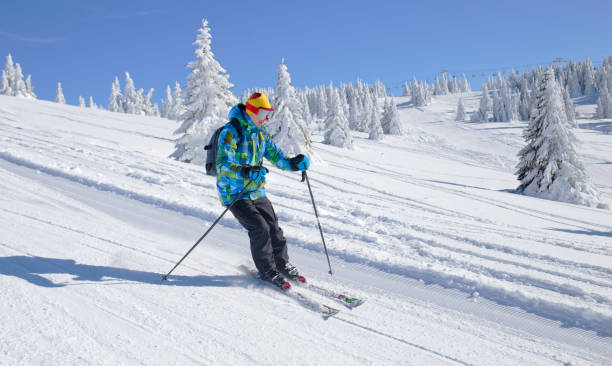 istock Active Skier skiing downhill on ski piste in mountains 1198449631