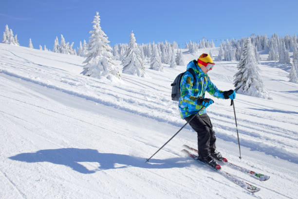 istock Active Skier skiing downhill on ski piste in mountains 1198449671