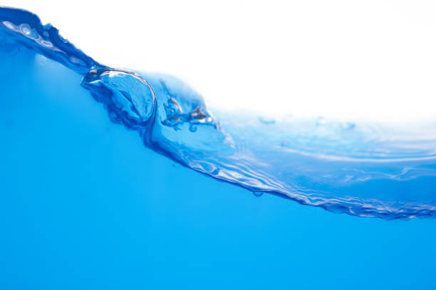 Closeup view of dynamic flowing blue water waves on white background. Liquid splash. Texture and abstract background