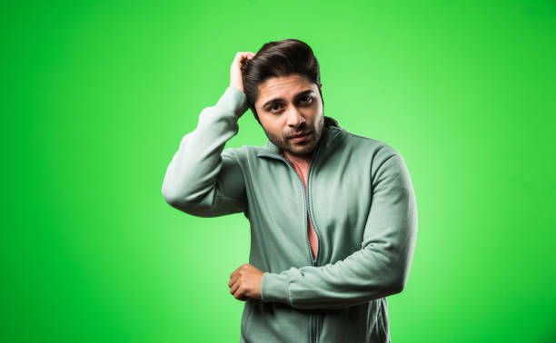 istock Handsome Indian / asian depressed man standing isolated over green background looking stressed and nervous having  Anxiety problem. selective focus 1198451122