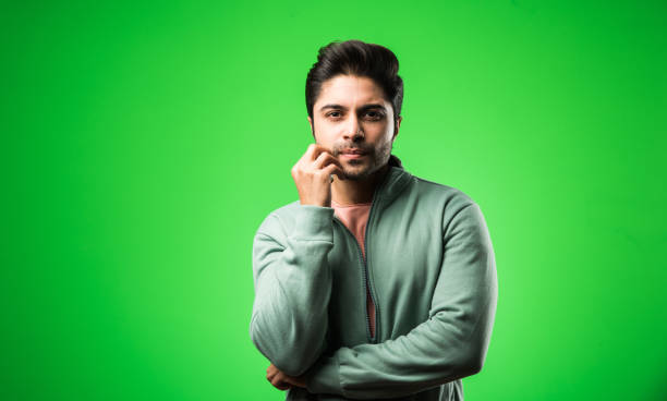 istock Handsome Indian / asian depressed man standing isolated over green background looking stressed and nervous having  Anxiety problem. selective focus 1198451161