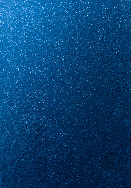 Glowing Blue glitter background .Christmas lights defocused background