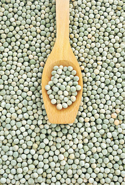 Wooden spoon and dried green peas
