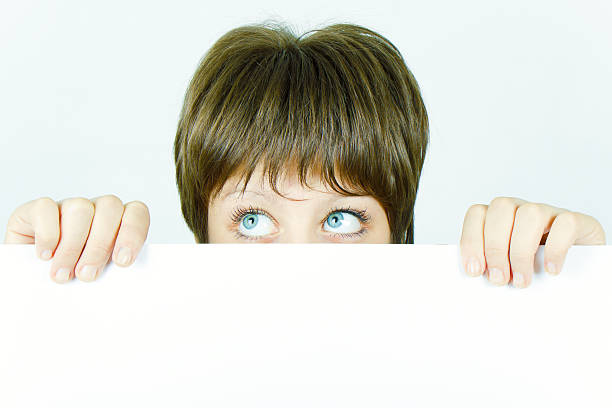 istock girl hiding behind a poster 119845446