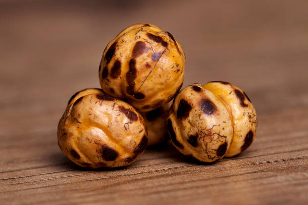 Roasted and dry chickpeas on wooden table.