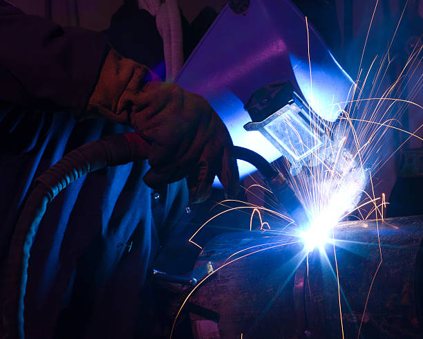 Dramatic blue-lit MIG welding close  oxyacetylene stock pictures, royalty-free photos & images