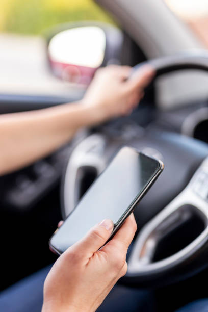istock Woman driving a car and typing a text message 1198458966