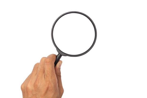 istock business man hand with magnifying glass isolated on white background 1198459224