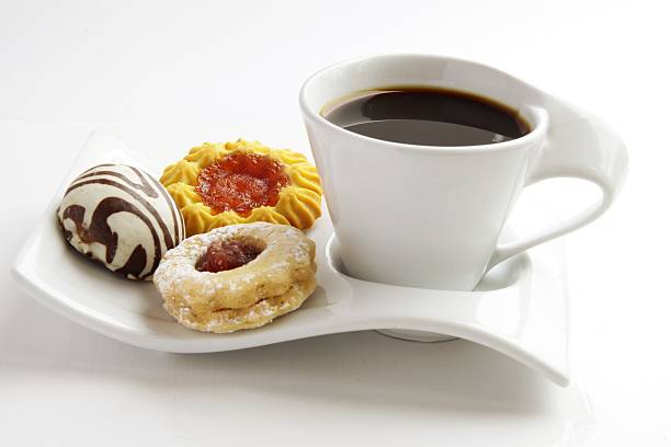 cup of black coffee and some cakes stock photo