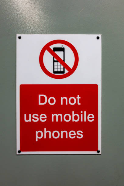 istock Do not use mobile phones warning sign 1198462496