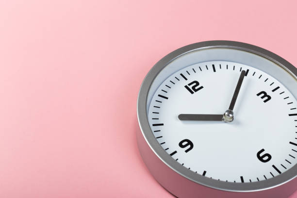 istock minimalistic white wall clock with light metal on a pink background. time concept. 1198462542